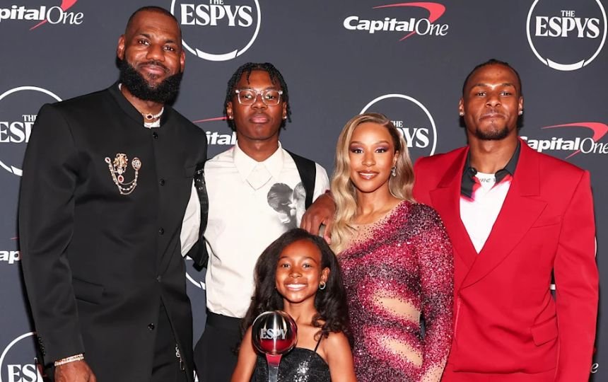 Savannah James with husband and children at public event with trophy